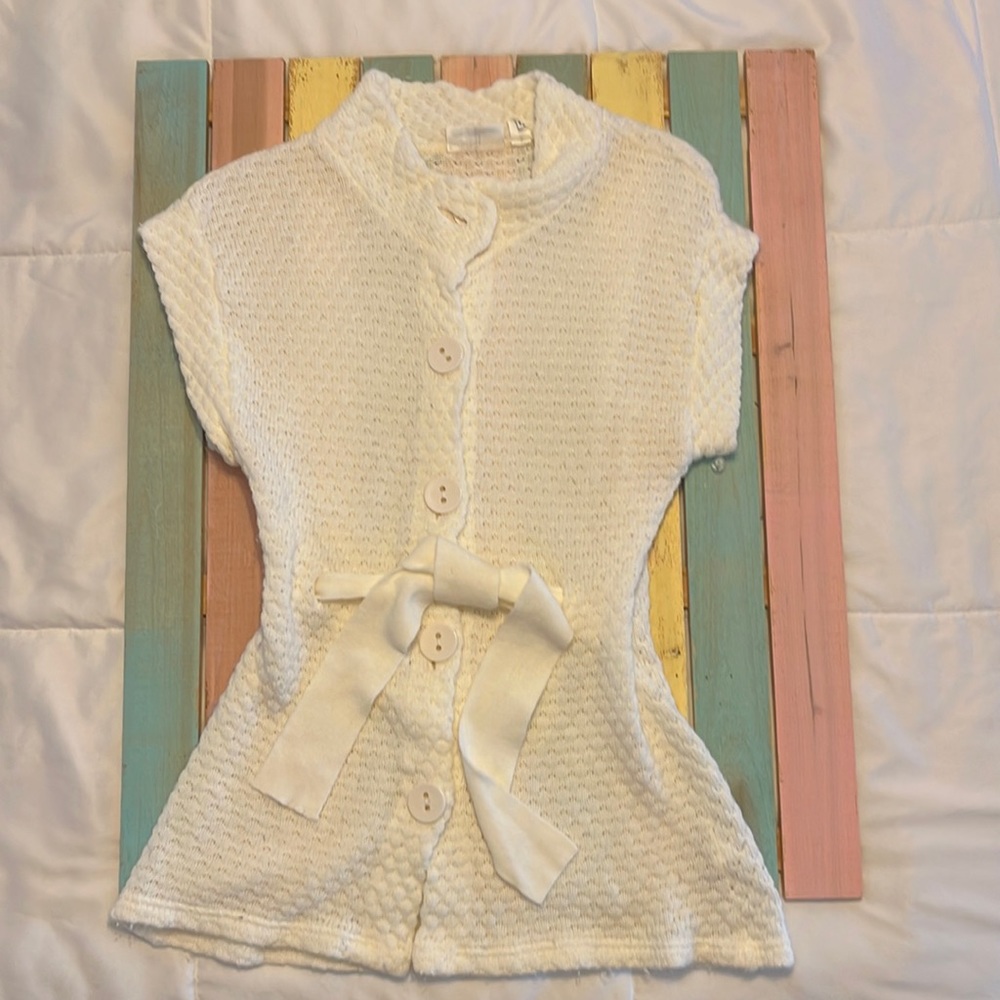 Cream color, light weight, sleeveless sweater jacket.